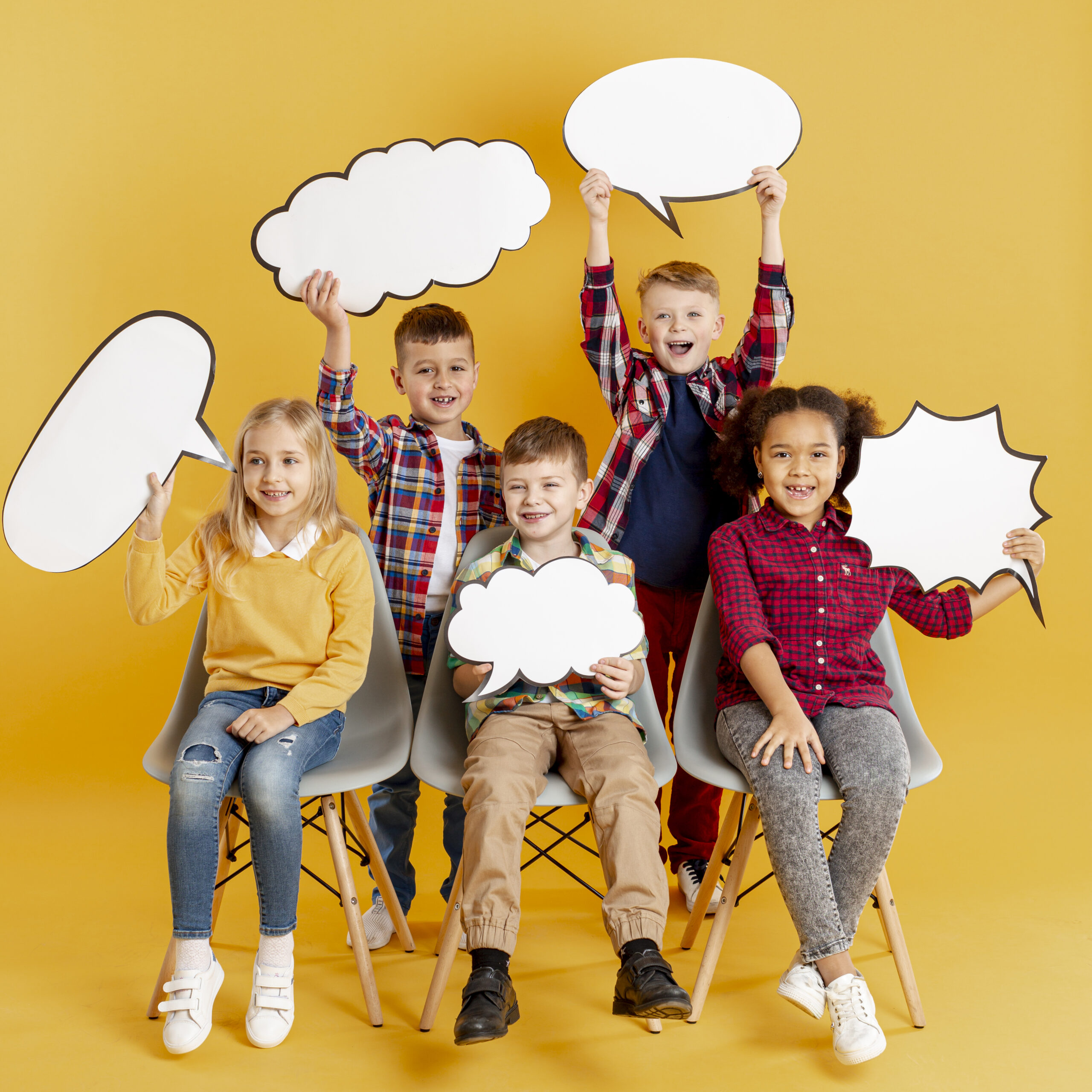 high-angle-childrens-holding-chat-bubbles